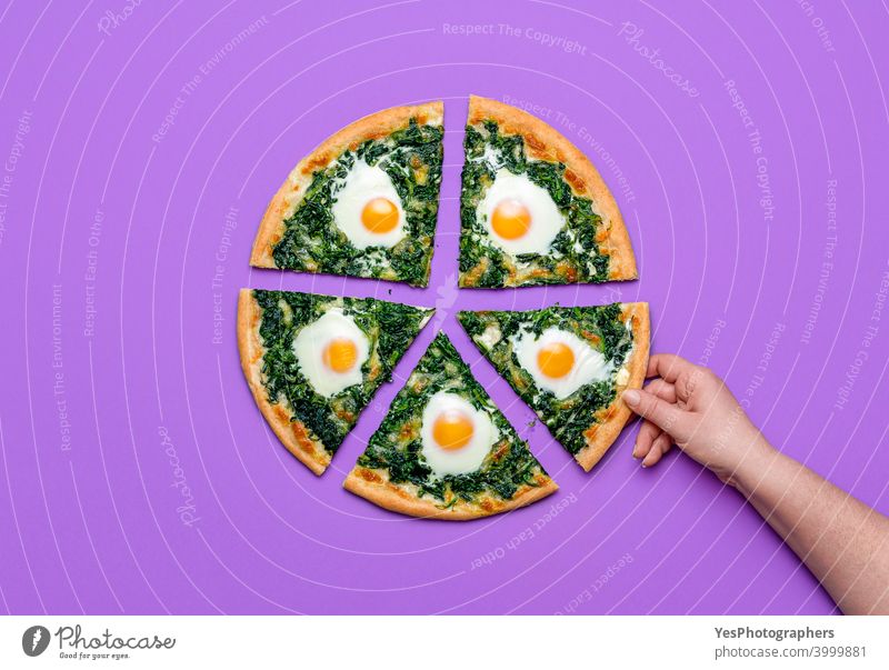 Sliced pizza with spinach and eggs. Woman taking a slice of pizza, flat lay Italian cheese colored background cuisine cut out delicious dinner directly above