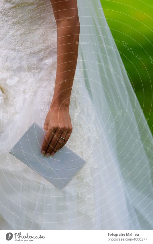 bridal hand with enveloppe beauty bride card celebration close-up congratulating decoration detail envelope female greeting greeting card holding human hand