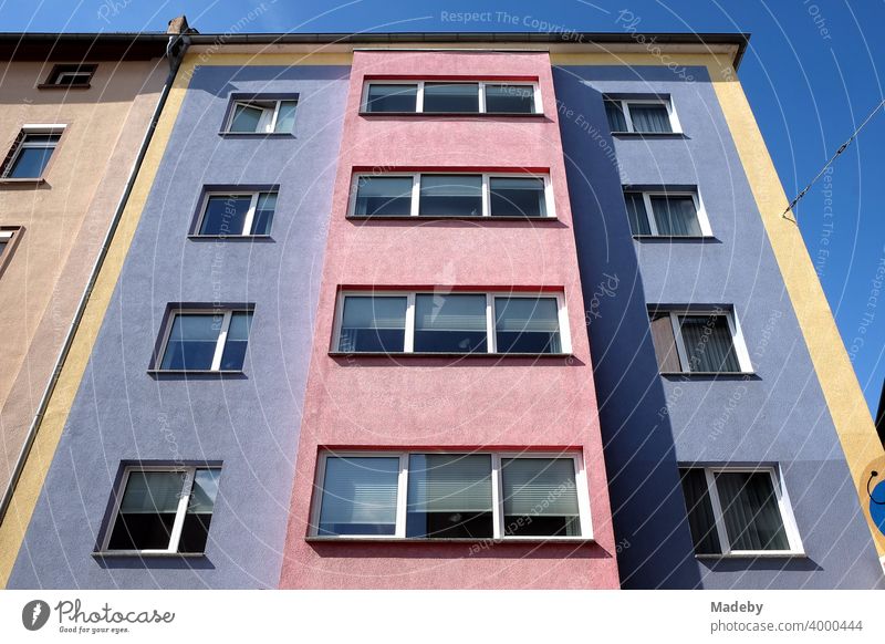 Colourful and contrasting facade in the style of the fifties in front of a blue sky in sunshine in the north end of Frankfurt am Main in Hesse Facade wohhaus