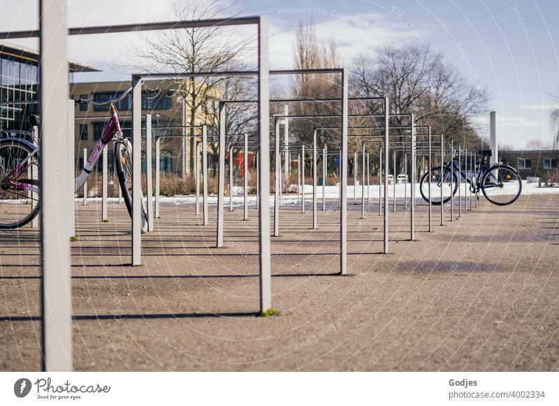 Bicycle stand in a public place with two bicycles Bicycle rack Cycling Exterior shot Parking Deserted Means of transport Colour photo Transport Town Day