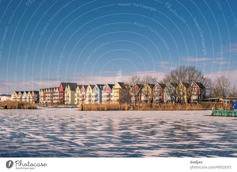 Swedish houses/ colourful wooden houses at a partly frozen river Panorama (View) Sunset Sunrise Evening Serene Skerry Colour photo Exterior shot Clouds Sunlight