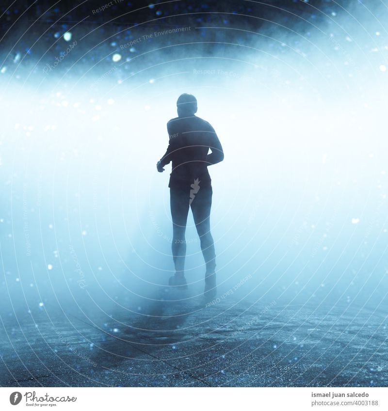 man running on the street in foggy days in winter season one person marathon runner jogging action fitness health lifestyle jogger sport exercise athletic speed