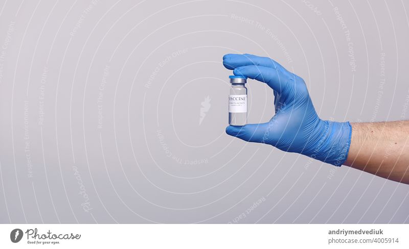 Development and creation of a coronavirus vaccine COVID-19 .Coronavirus Vaccine in glass bottle in hand of doctor on gray background. Vaccine Concept of fight against coronavirus.