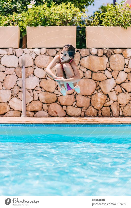 young little naked kid boys an girls Little child jumping into a pool - a Royalty Free Stock Photo from Photocase