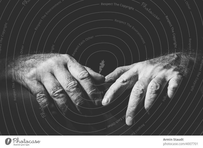 two relaxed hands lying next to each other adult black black and white bright bw closeup contain contrast dark embrace expression finger gesture grab hold