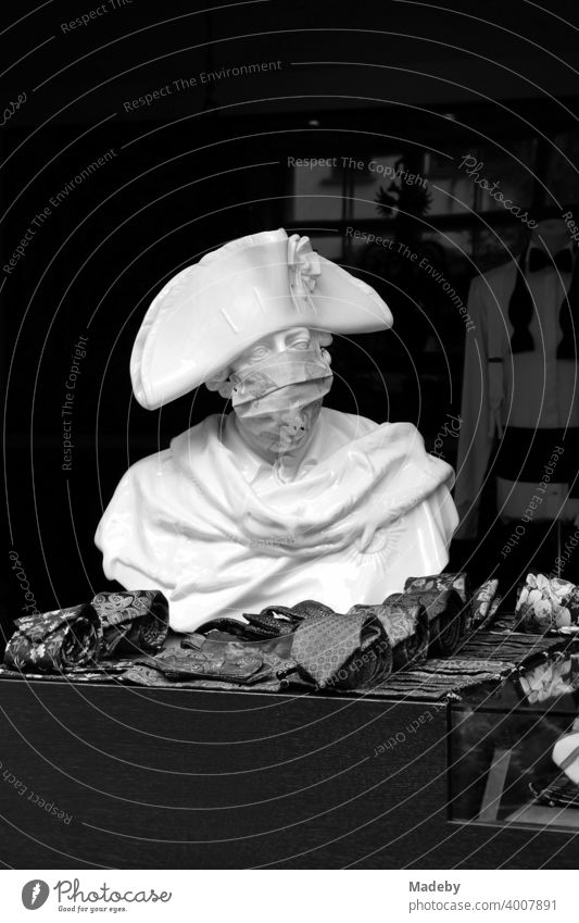 Bust of Frederick the Great with mouth guard in front of the shop of a men's outfitter in the Hackesche Höfe at Hackescher Markt in the capital Berlin, photographed in neo-realistic black and white