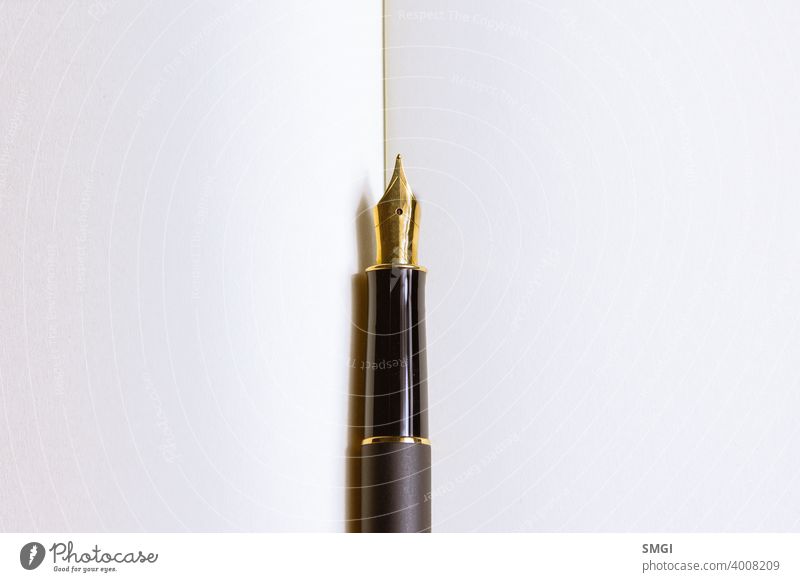 Close-up of a fountain pen on a notebook. Concept of writing poetry.  International Poetry Day - a Royalty Free Stock Photo from Photocase