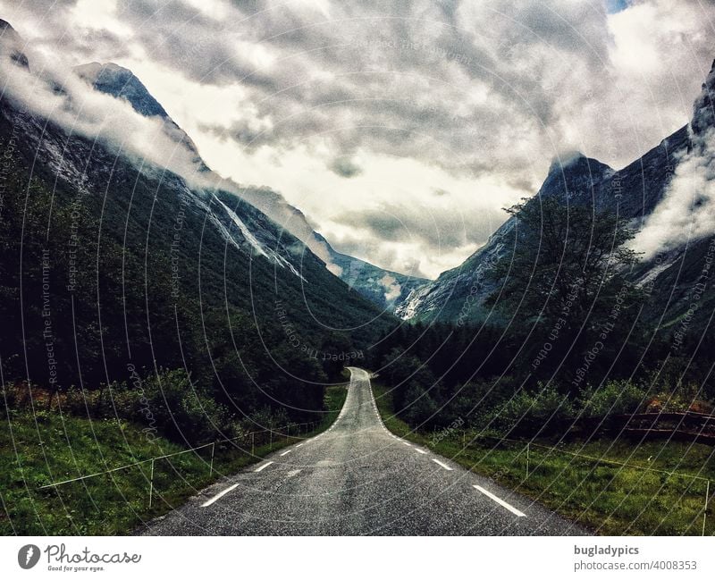 Road into the clouds Street Wilderness Mountain mountains Mountains in the background Mountains and mountain ranges Clouds cloudy cloudy sky Green rocky travel