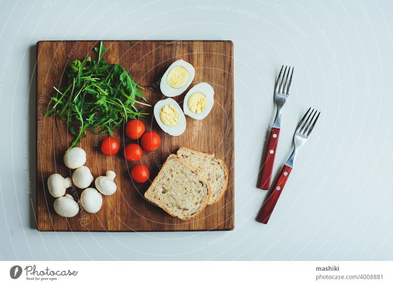 Ingredients to make vegetarian bruschetta with cherry tomatoes, arugula, mushrooms and boiled eggs. Healthy food breakfast Tomato Mushroom Cherry Tomato Egg