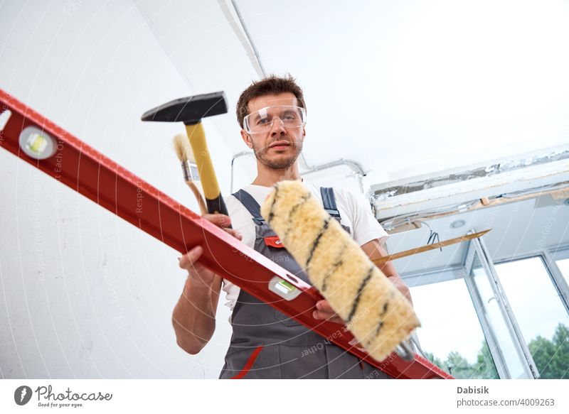 Builder man with construction tools. Repair concept renovation repair instrument equipment handyman protection builder male worker protective people craftsman