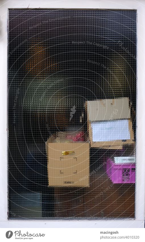 Cartons in a storage room behind ribbed glass cartons behind glass Diffuse blurriness Glass Window pane Pane Copy Space Slice Transparent transparent