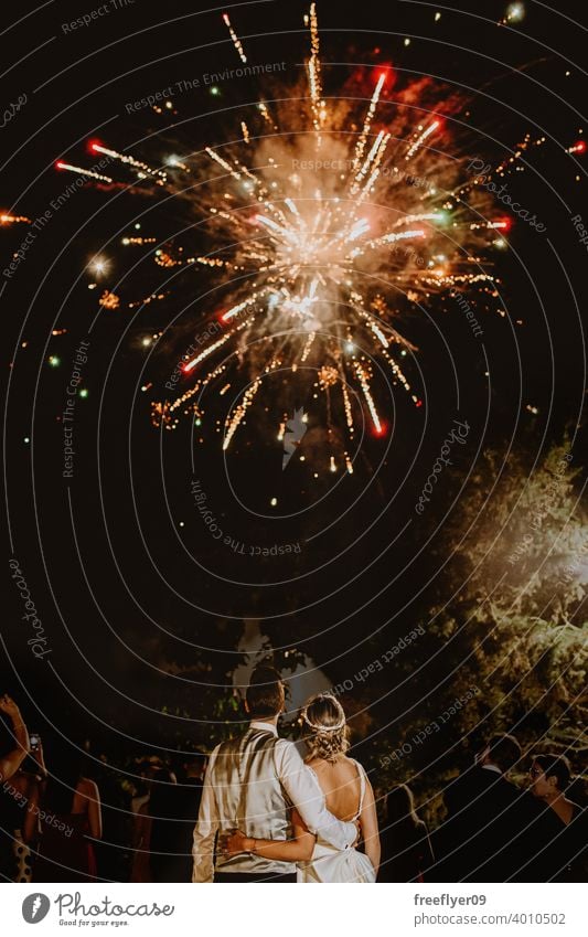Young couple on their wedding contemplating some fireworks night explosion event luxury marriage engagement bride people young attractive copy space landscape
