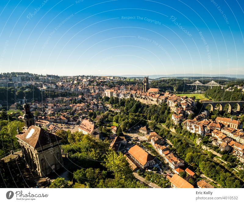 Landscape panoramic view of the city of Fribourg in Switzerland, with the Saint-Nicolas cathedral in the background Europe european Swiss landscape cityscape