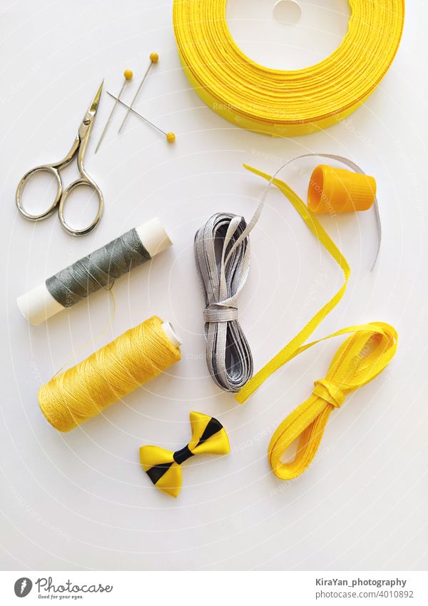 Sewing Kit Accessories And Equipment For Sewing Yellow Shades. Various Sewing  Accessories And Tools For Needlework: Fabric, Threads, Scissors, Buttons,  Needles, Braid, Ribbons. Flat Lay, Top View Stock Photo, Picture and Royalty