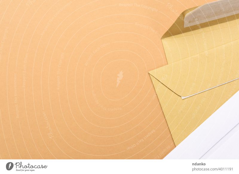 blank white paper brown and white envelopes on a brown background letter empty message office post card document mail postage stationery delivery communication