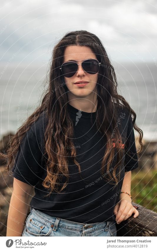 A young woman near the coastline in Port Macquarie, Australia. Woman Women Girl Girls Female Young Teen Teenager 20s Adult Long Hair Glasses Brown Black