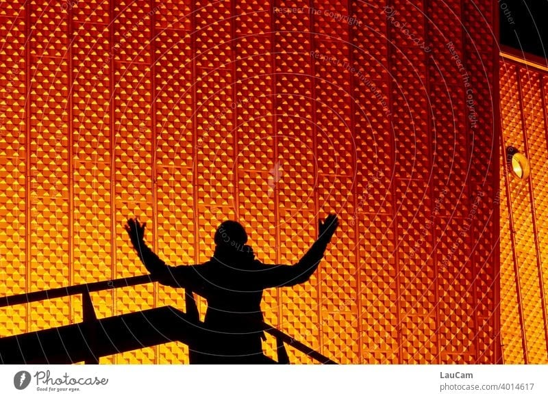 Shadow plays in front of the Berlin Philharmonic Hall philharmonic orchestra Night Evening Orange Gold silhouette luminescent Abstract structure Facade Sharoun