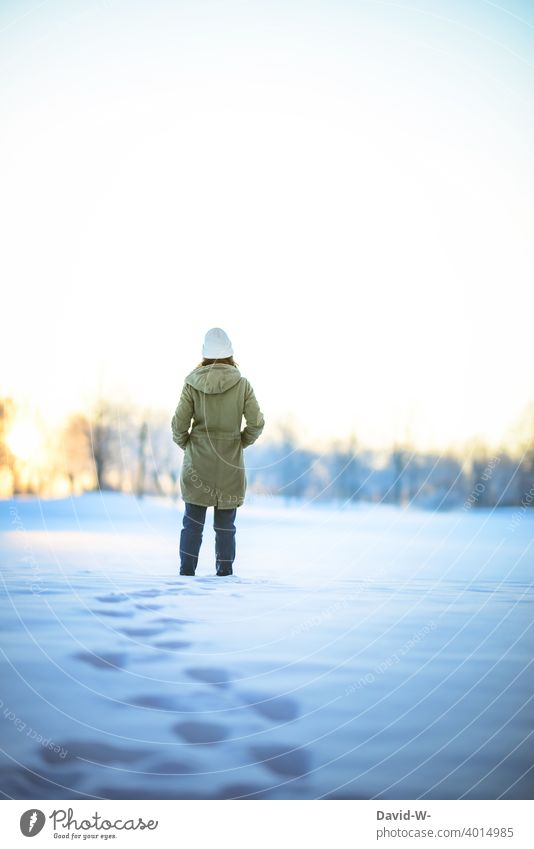 Woman takes a winter walk through the snow and enjoys the silence Winter walk Snow Nature Winter's day onset of winter chill Freeze tranquillity To enjoy