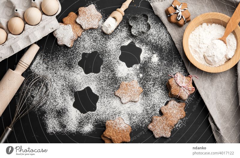 Baked star-shaped gingerbread cookies powdered with sugar for