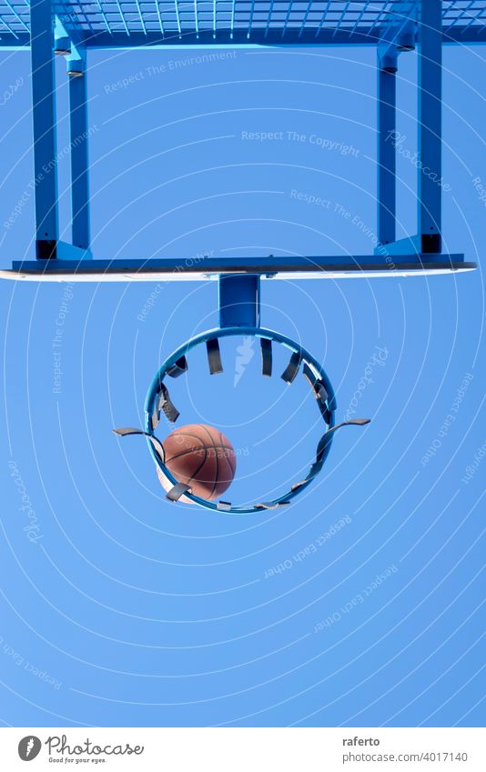 Basketball hit the net, the goal is achieved. Low angle view nobody hoop basketball score sport court equipment succeed scoring success shoot game play