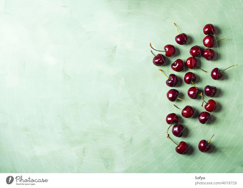 Fresh summer cherries berries on green background. Copy space cherry fruit red food organic wash top fresh kitchen clean leaf table sweet berry above ripe dark