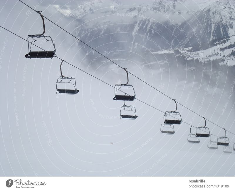 compliant | with corona rules - lonely standing chairlift in ski area | corona thoughts chair lift Skiing standstill Empty forsake sb./sth. Fog switched off
