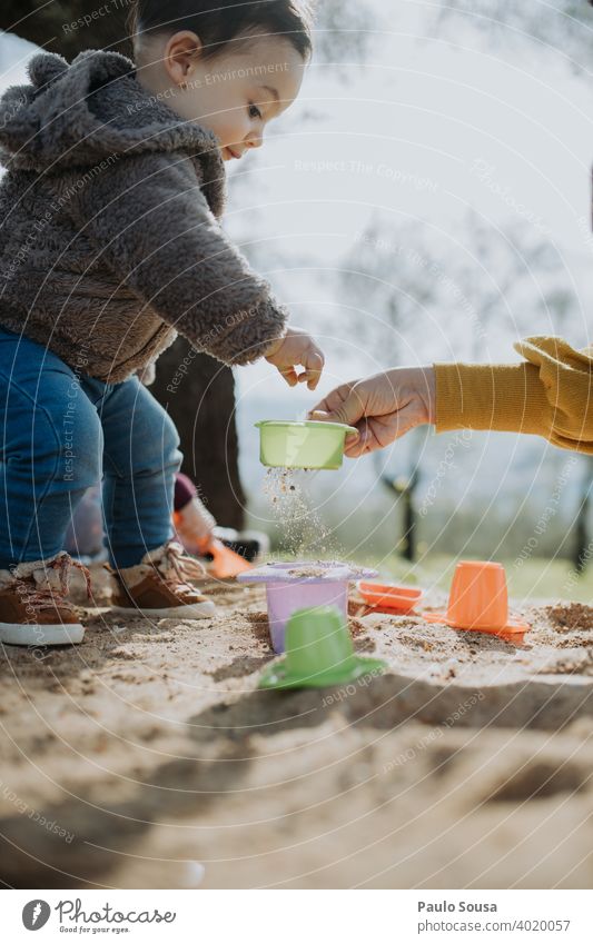 Child playing outdoors with sand Playing Sand Spring Joy Boy (child) childhood Playground Sandpit Beach Toddler Infancy girl Kindergarten Exterior shot