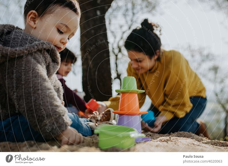 Child playing outdoors with sand Family & Relations Mother with child motherhood Parenting Playing Toddler 1 - 3 years Infancy Together Joy Love Happiness Life