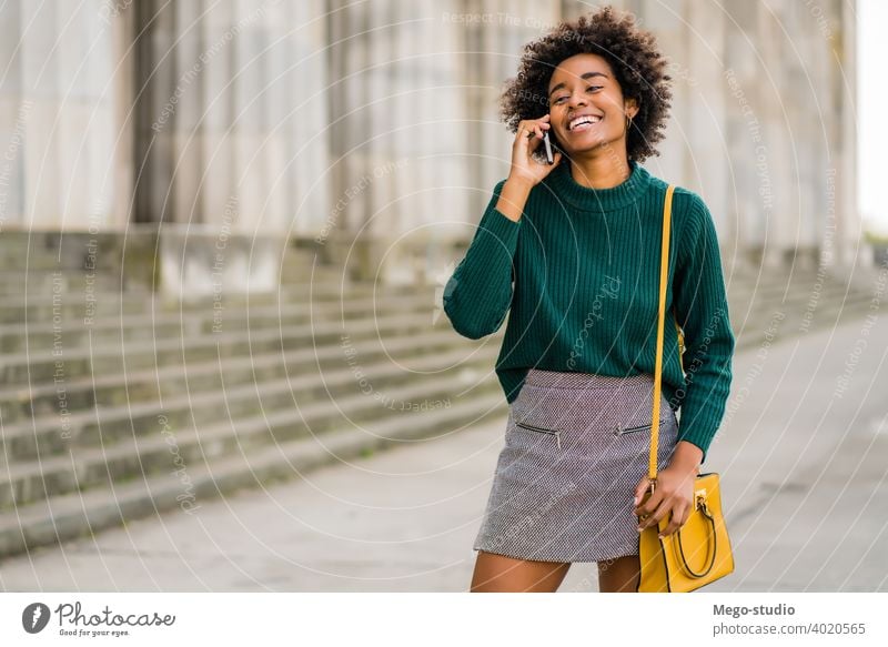 Business woman talking on the phone outdoors. afro business mobile modern style brunette gadget positive concept connection application sms texting