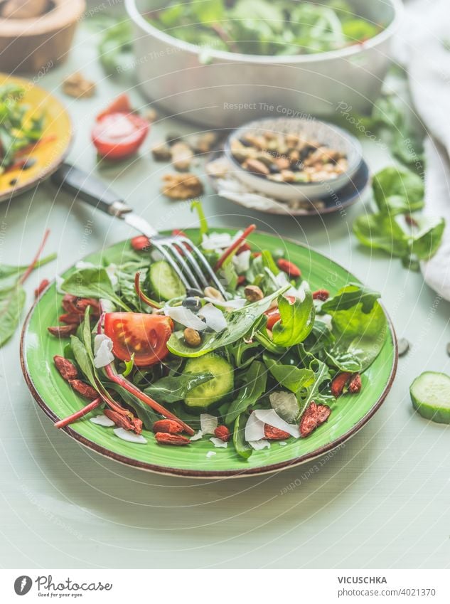 Close up of green vegan salad with nuts topping and fork. Lunch food. background close up concept cuisine delicious detox diet dish fasting fresh health healthy