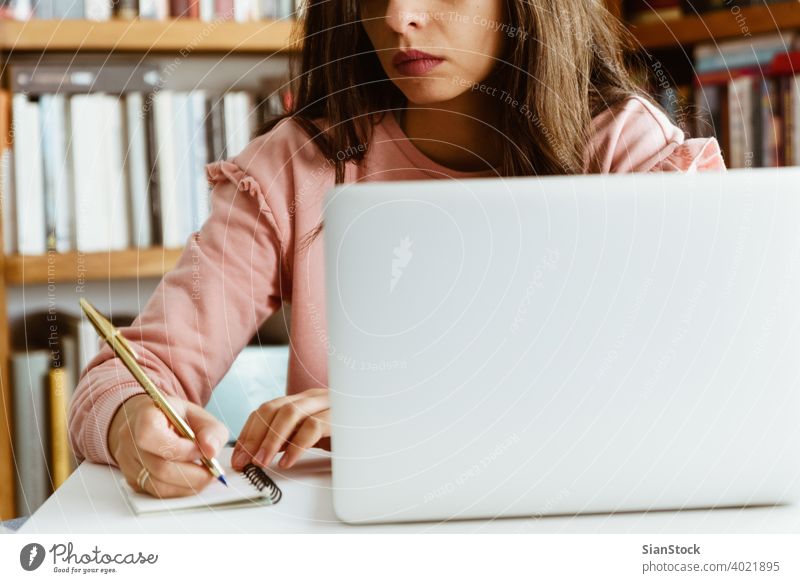 Young woman working on white marble desk at her home. young person hand table female notes library wooden pen business top background morning girl adult