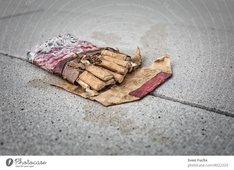 A crushed pack of cigarettes lies on the concrete floor Cigarette box Smoking quit smoking crumpled up Healthy