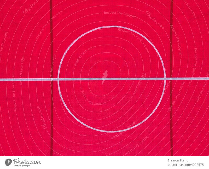 Plastic outdoor basketball court  floor, detail. Outdoor sport ground with red surface for playing basketball  in urban area, above. abstract activity backdrop