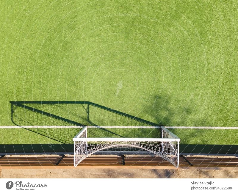 Green Soccer Court Detail .Outdoor sport ground with green surface for playing football  or soccer  in urban area, detail activity artificial backdrop