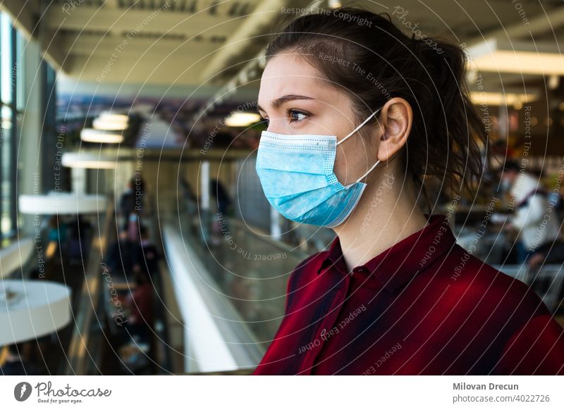 Beautiful pretty worried caucasian young woman wearing protective surgical face mask anxiety attractive buying caution contagious corona coronavirus covid-19