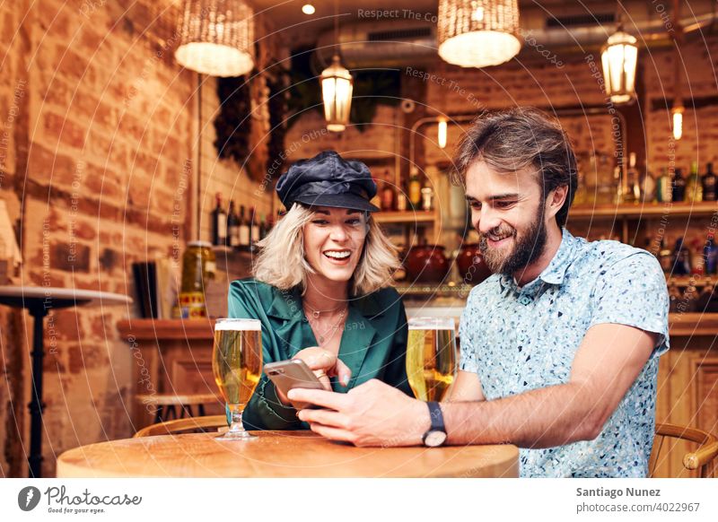 Caucasian couple having a drink at a bar. adult woman people happy female lifestyle two caucasian beautiful together smile love joy boyfriend indoors romance