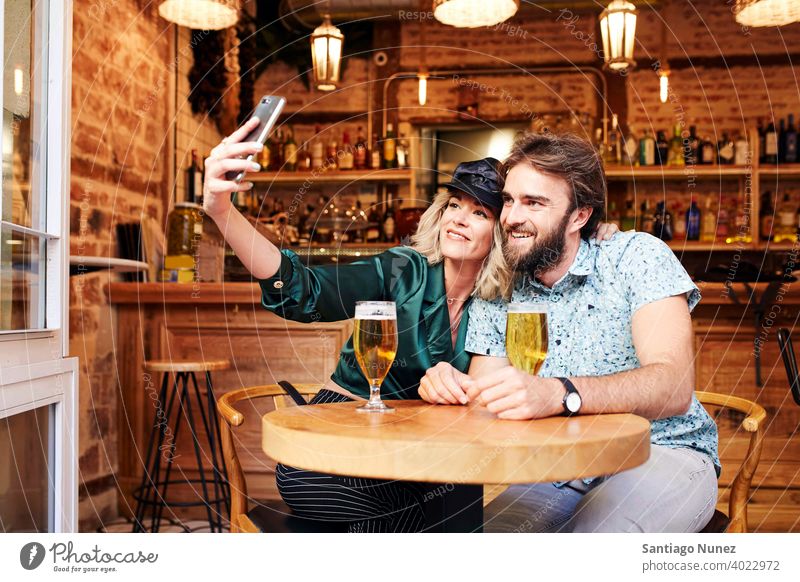 Caucasian couple having a drink at a bar. adult woman people happy female restaurant lifestyle two caucasian happiness smile boyfriend romantic indoors romance