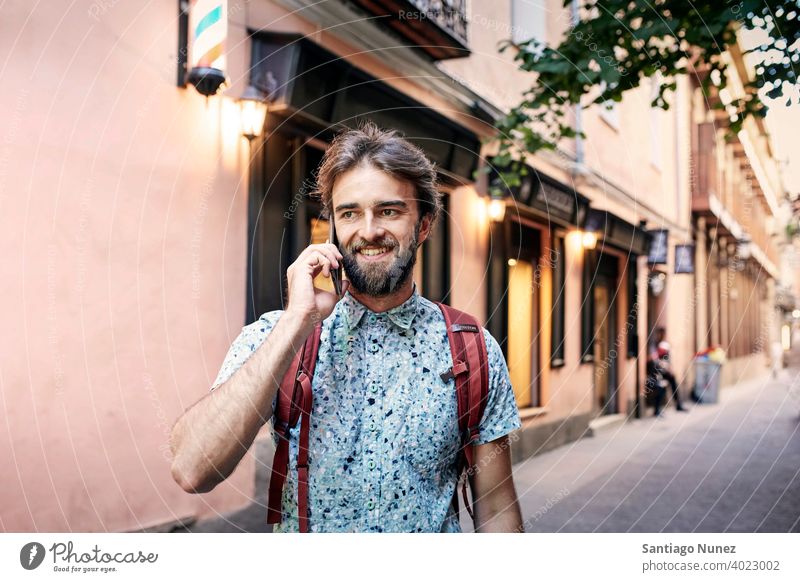 Man being on his phone on the streets. adult happy lifestyle caucasian happiness smile fun love joy leisure cheerful laughing date smiling enjoyment 30s