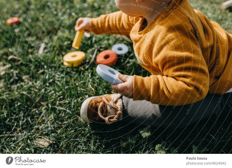 Child playing with toys in the grass childhood Unrecognizable Toys activity joy happy outdoors little unrecognizable kid lifestyle nature Playing Education
