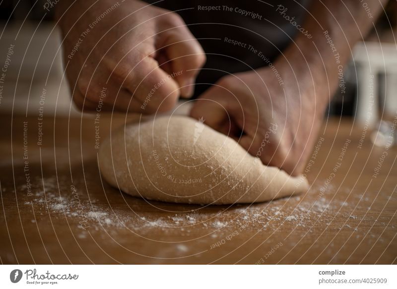 A dough is kneaded on a kitchen table Dough pizza dough Kitchen Kitchen Table Flour dust Self-made Baking Bakery Baked goods Bread bread dough hands Fist Child