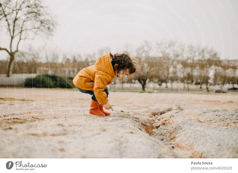 Side view of child with red rubber boots playing outdoors Red Child childhood Joy Infancy Childhood memory Toddler Boy (child) Happiness Colour photo