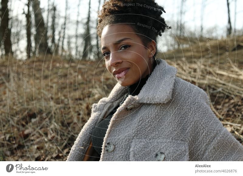 Young woman in fur jacket standing in nature by a lake Woman Athletic Dark-haired Long-haired pretty Strong Graceful naturally Curly Slim Nature Jewellery Chain