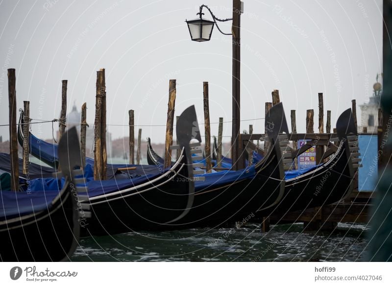 View in the rain on a mooring place of gondolas in Venice Lagoon Rain Gondolier Water Watercraft Italy Boating trip Tourism Port City Navigation Channel