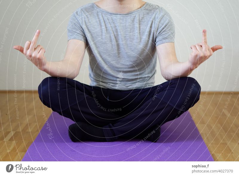 Stress management - Man sitting in cross legged position showing both middle fingers stress management meditation work life balance fuck stressed yoga burnout