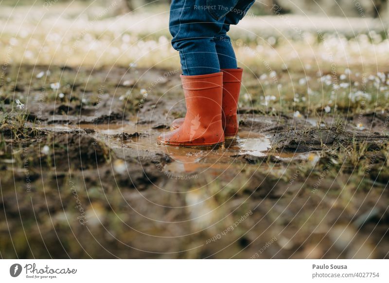 Child with red rubber boots playing on a puddle Puddle Red Rubber Rubber boots childhood Weather Human being Water Playing Infancy Boots Joy Wet Rain Authentic