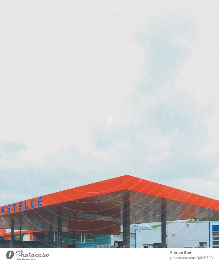 Gas station roof in signal color under cloudy sky Petrol station Roof construction Transport Esthetic Aesthetics Architecture Colour abstract photography