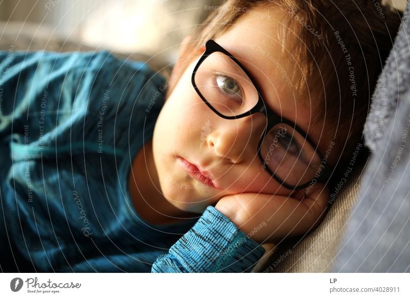 beautiful child wearing glasses looking very serious into the the camera puzzled Perplexed sceptical scepticism doubts Doubt hestitate uncertainty confusion