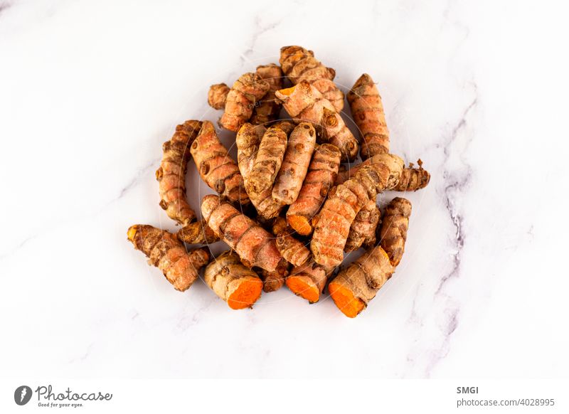 Set of various turmeric roots on a marble table. Concept of natural medicine and homeopathy spice ingredient seasoning fresh organic isolated curcuma horizontal