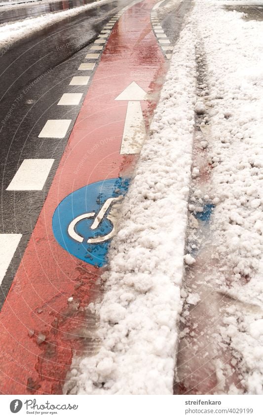 Clear ahead! - Red bike lane pushes out from under the snow ride a bike ride a bicycle Winter Snow Street Blue symbol Transport Driving Bicycle