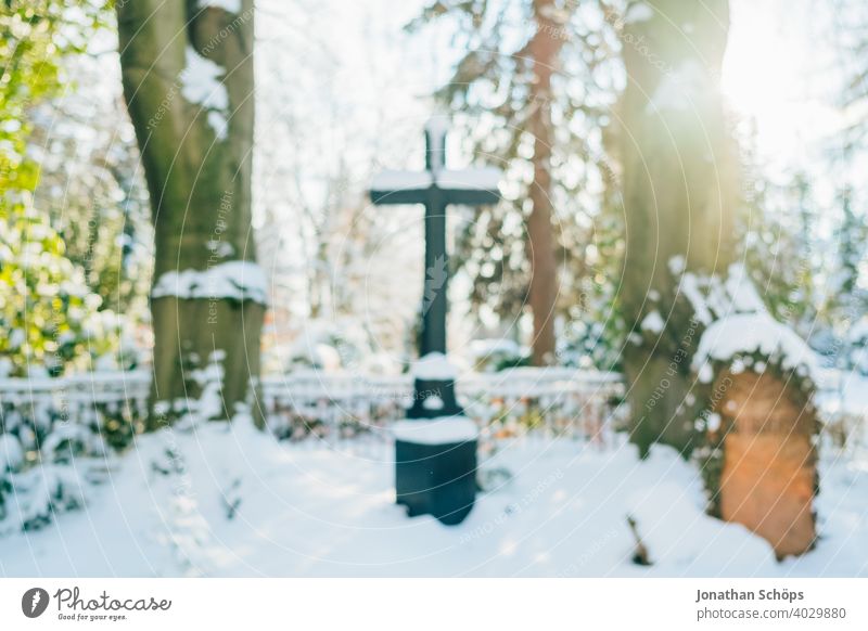 Grave in cemetery in winter with snow death and eternity Goodbye Funeral bokeh Christianity Coronatote Corona winter Eternity Cemetery Prayer commemoration